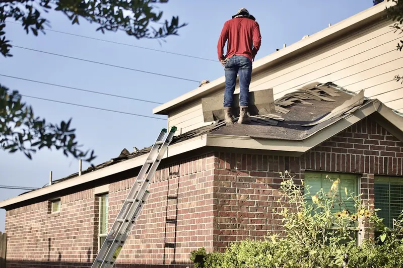 Professional roofer working on a residential roof in Woodhaven